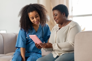 Patient and Doctor on couch looking at tablet